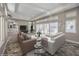 Spacious living room featuring an open floorplan with cozy seating, decorative tiling, and natural light at 2017 Slow Wind St, Las Vegas, NV 89134