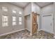 Bright mud room with multiple windows, custom tile floors, and sliding barn door to bathroom at 2017 Slow Wind St, Las Vegas, NV 89134