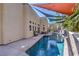 Backyard pool area with patio, landscaping, and colorful sunshades at 2017 Slow Wind St, Las Vegas, NV 89134