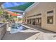Sparkling pool with covered patio and lush tropical plants in the well-manicured backyard at 2017 Slow Wind St, Las Vegas, NV 89134