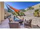 Backyard pool area with comfortable outdoor seating and shade sails for relaxation at 2017 Slow Wind St, Las Vegas, NV 89134