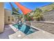 Inviting plunge pool area with sunshades, mature palms, and privacy wall at 2017 Slow Wind St, Las Vegas, NV 89134