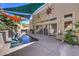 Inviting pool area with a covered patio, lush plants, and ample patio space at 2017 Slow Wind St, Las Vegas, NV 89134