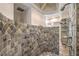 Shower area featuring stone tile, dual showerheads, and open design at 2017 Slow Wind St, Las Vegas, NV 89134