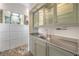 Stylish wet bar area with stainless steel counter and muted green cabinetry at 2017 Slow Wind St, Las Vegas, NV 89134