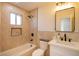 Updated bathroom with a tub, shower, and modern vanity at 233 Pecos Way, Las Vegas, NV 89121