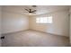 Spacious bedroom featuring neutral carpet, ceiling fan, and a window allowing natural light at 233 Pecos Way, Las Vegas, NV 89121