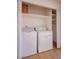 Convenient laundry area with washer, dryer, and built-in shelving for storage at 233 Pecos Way, Las Vegas, NV 89121