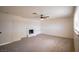 Bright living room with neutral carpet, ceiling fan, and fireplace providing a cozy feel at 233 Pecos Way, Las Vegas, NV 89121