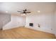 Bright living room with fireplace, ceiling fan and new floors at 233 Pecos Way, Las Vegas, NV 89121
