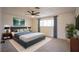 Primary bedroom with modern decor, a ceiling fan, and natural light at 233 Pecos Way, Las Vegas, NV 89121