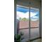 Sliding glass patio door reveals the brick enclosed patio at 233 Pecos Way, Las Vegas, NV 89121