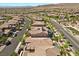 An aerial view showing the backyard pools and the surrounding neighborhood at 251 Castellari Dr, Las Vegas, NV 89138