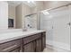 Bathroom features a dark wood vanity with a quartz countertop and glass shower at 251 Castellari Dr, Las Vegas, NV 89138