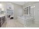 Bright primary bathroom features a tub, glass shower, dark wood vanity, and dual sinks at 251 Castellari Dr, Las Vegas, NV 89138