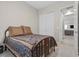 Cozy bedroom features an iron bed frame, patterned bedding and a view into the hallway at 251 Castellari Dr, Las Vegas, NV 89138