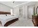 Bright primary bedroom with a king bed, ensuite bathroom, and dark wood furniture at 251 Castellari Dr, Las Vegas, NV 89138