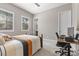 Comfortable bedroom with carpet flooring, a desk, and natural light from large windows at 251 Castellari Dr, Las Vegas, NV 89138