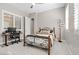 Cozy bedroom with a desk, carpet flooring, and natural light from large windows at 251 Castellari Dr, Las Vegas, NV 89138