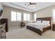 Spacious bedroom with plantation shutters, tray ceiling, fan and carpeted floors at 251 Castellari Dr, Las Vegas, NV 89138