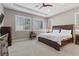 Spacious bedroom with plantation shutters, tray ceiling, fan and carpeted floors at 251 Castellari Dr, Las Vegas, NV 89138