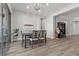 Bright dining room with hardwood floors, modern chandelier, and large sliding glass doors to the outside at 251 Castellari Dr, Las Vegas, NV 89138