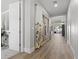 Inviting hallway featuring hardwood floors, leading to a dining area with backyard patio access at 251 Castellari Dr, Las Vegas, NV 89138