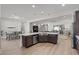 Spacious kitchen with open layout, large island, stainless steel appliances, and dining area view at 251 Castellari Dr, Las Vegas, NV 89138