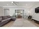 Cozy living room with a decorative rug, stylish furniture, and bright natural light through sliding glass doors at 251 Castellari Dr, Las Vegas, NV 89138