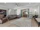 Open-concept living room with hardwood floors, a ceiling fan, and backyard patio access at 251 Castellari Dr, Las Vegas, NV 89138