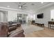 Open-concept living room with hardwood floors, a ceiling fan, and backyard patio access at 251 Castellari Dr, Las Vegas, NV 89138