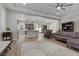 Open-concept living room adjacent to a kitchen with hardwood floors and ample space at 251 Castellari Dr, Las Vegas, NV 89138