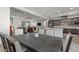 Open concept kitchen, dining, and living area with a gray color palette and hardwood floors at 251 Castellari Dr, Las Vegas, NV 89138