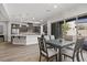 Open concept kitchen, dining, and living area with a gray color palette and hardwood floors at 251 Castellari Dr, Las Vegas, NV 89138