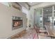 Outdoor fireplace on a covered patio with brick flooring and a view of the interior at 251 Castellari Dr, Las Vegas, NV 89138