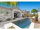 Stunning in-ground pool with mosaic waterfall and lush landscaping, creating the perfect backyard retreat at 251 Castellari Dr, Las Vegas, NV 89138