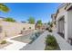 Inviting in-ground pool with mosaic waterfall, surrounded by lush landscaping for a private backyard retreat at 251 Castellari Dr, Las Vegas, NV 89138