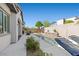 Beautiful in-ground pool with a mosaic waterfall feature, ideal for outdoor relaxation and backyard enjoyment at 251 Castellari Dr, Las Vegas, NV 89138