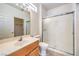 Clean bathroom with a vanity, a toilet, and a shower featuring sliding glass doors at 2535 Leighton Ave, Henderson, NV 89052