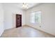 Well-lit bedroom featuring neutral walls, tile flooring, a ceiling fan, and a large window at 2535 Leighton Ave, Henderson, NV 89052