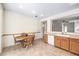 Cozy dining area with an adjacent breakfast bar, tiled flooring, and a view of the living room at 2535 Leighton Ave, Henderson, NV 89052
