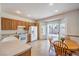 Cozy kitchen and dining area featuring tile floors, a gas range, and sliding glass doors to the backyard at 2535 Leighton Ave, Henderson, NV 89052