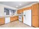 Efficient kitchen features wood cabinets, white appliances, and an open view to the living space at 2535 Leighton Ave, Henderson, NV 89052