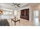 Bright living room with tile floors, ceiling fan, and a large built-in bookcase with ample storage at 2535 Leighton Ave, Henderson, NV 89052