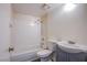 Bright bathroom with a shower-tub combo, white tile and a sleek single sink vanity at 2696 Jennydiane Dr, Las Vegas, NV 89121