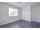 Cozy bedroom featuring light gray wood floors, white walls, and a sliding door closet at 2696 Jennydiane Dr, Las Vegas, NV 89121
