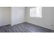 Comfortable bedroom with wood-look flooring, ample natural light, and a spacious closet for storage at 2696 Jennydiane Dr, Las Vegas, NV 89121