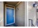 Inviting entryway featuring a modern blue front door, a stylish light fixture, and neutral siding at 2696 Jennydiane Dr, Las Vegas, NV 89121