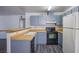 Functional kitchen with sleek appliances, gray cabinets, and light wood countertops, perfect for cooking and dining at 2696 Jennydiane Dr, Las Vegas, NV 89121