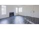 Bright living room with light gray wood floors, white walls, and a cozy fireplace at 2696 Jennydiane Dr, Las Vegas, NV 89121
